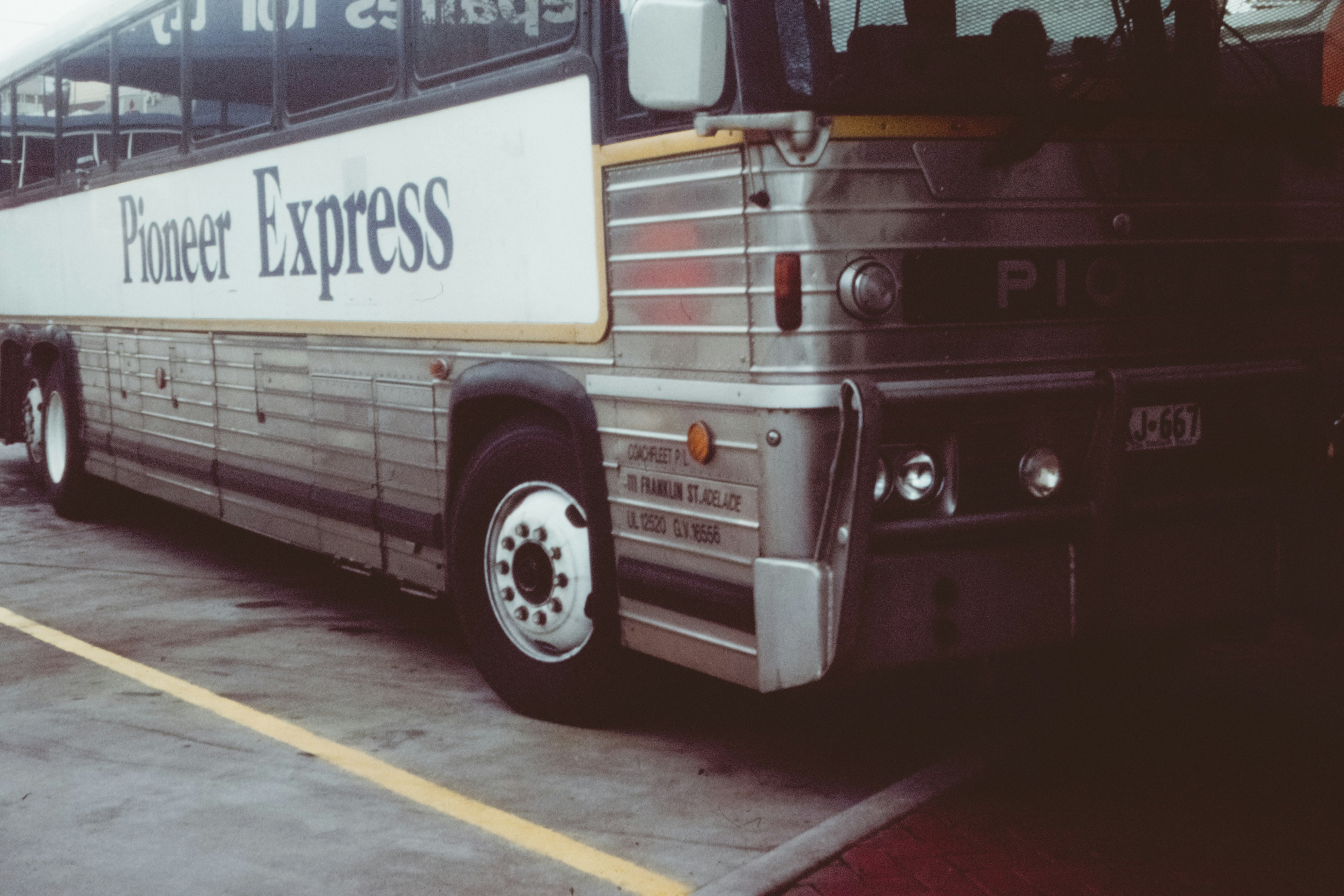 grey and white Pioneer Express bus